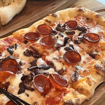 Capriccio - Happy Hour Oval Pizza with Pepperoni and Olives - Italian Near Me - Miami, Florida Capriccio - Happy Hour Oval Pizza with Pepperoni and Olives - Italian Near Me - Miami, Florida
