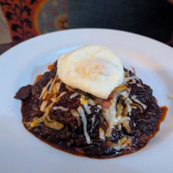 The Original Blue Adobe Grille - Stacked enchiladas with an egg on top