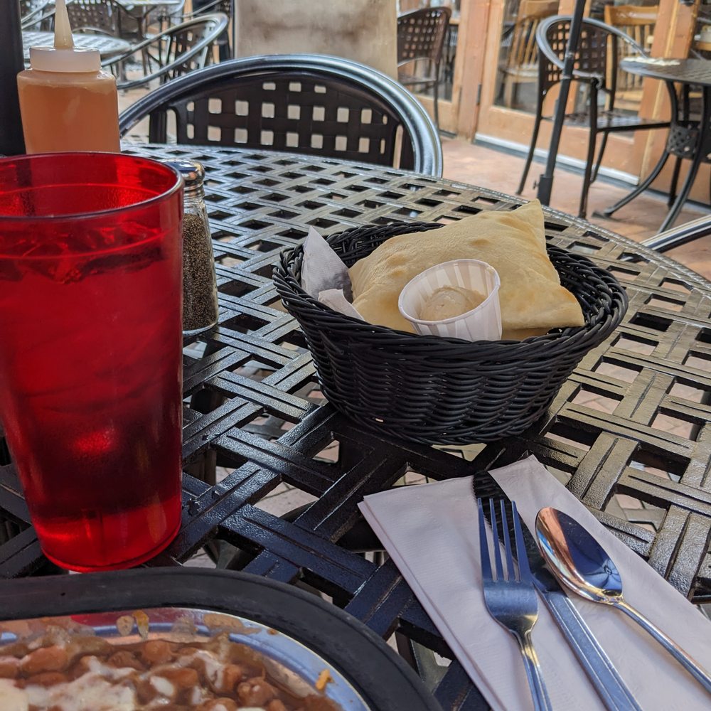 Tomasita's - outside table and complimentary sopapillas with honey butter - New Mexican Cuisine Near Me - Santa Fe, New Mexico Tomasita's - outside table and complimentary sopapillas with honey butter - New Mexican Cuisine Near Me - Santa Fe, New Mexico