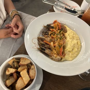 Couvant - Shrimp and grits and rosemary potatoes - Brasseries Near Me - New Orleans, Louisiana Couvant - Shrimp and grits and rosemary potatoes - Brasseries Near Me - New Orleans, Louisiana