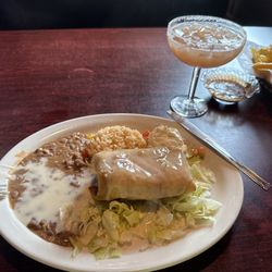 Jorrge's Restaurante Cantina - Chicken fajita Chimichanga with beans and rice and a dollop of sour cream. Guava golden margarita on the rocks, salt