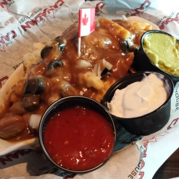 The Canadian Brewhouse - Nacho Poutine: black olives, jalapeños, onions and peppers with guacamole, salsa and sour cream - Canadian (New) Near Me - Calgary, Alberta The Canadian Brewhouse - Nacho Poutine: black olives, jalapeños, onions and peppers with guacamole, salsa and sour cream - Canadian (New) Near Me - Calgary, Alberta