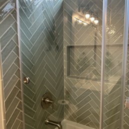 I have the before (plastic insert and curtain) and after (herringbone tile) photos. I have the before (plastic insert and curtain) and after (herringbone tile) photos.
