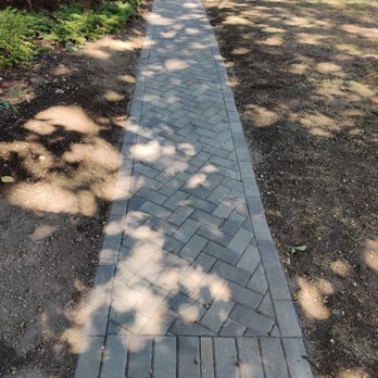 Imperial Landscaping - a brick walkway in a park - Landscaping Near Me