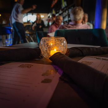 The Ruins - a candle on a restaurant table - Cocktail Bars Near Me - Lafayette, Louisiana