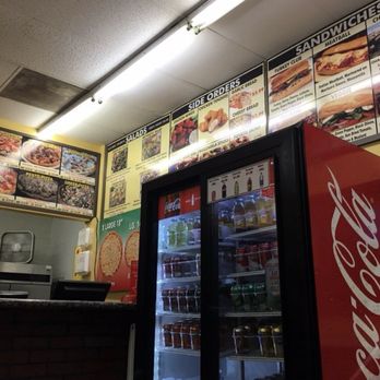 Lenzini's Pizza - inside the restaurant with a nice, big fridge with full of cold beverages.. An overhead menu.. - Pizza Near Me - North Hollywood, California Lenzini's Pizza - inside the restaurant with a nice, big fridge with full of cold beverages.. An overhead menu.. - Pizza Near Me - North Hollywood, California