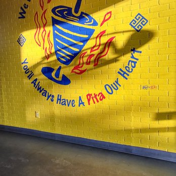 What About Kabobs - a yellow wall with a blue bowl of food on it - Mediterranean Near Me - Tyler, Texas What About Kabobs - a yellow wall with a blue bowl of food on it - Mediterranean Near Me - Tyler, Texas