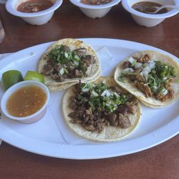 Street tacos of tripa, lengua, and carne asada Street tacos of tripa, lengua, and carne asada