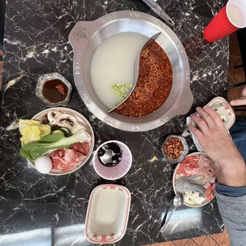 Four Seasons Hot Pot And Dumpling - Hot pot table with pork bone broth and spicy Chinese broth - Chinese Near Me - Provo, Utah