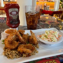 TJ Reed's Flippers - Coastal Seafood - Coconut shrimp on a bed of dirty rice with gravy coleslaw