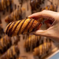 CAO Bakery & Cafe - A hand holding a nutella pastry.