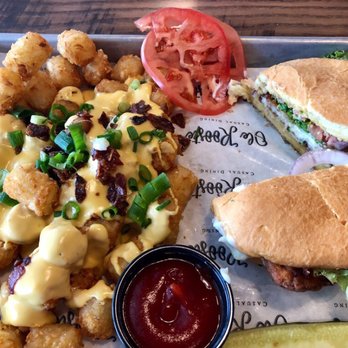 Ole Rooste - Breaded tenderloin sandwich with loaded tater tots. - American Near Me - Connersville, Indiana Ole Rooste - Breaded tenderloin sandwich with loaded tater tots. - American Near Me - Connersville, Indiana