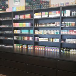 Ecig Vapor Juice Store - Cruiz is here and helpful. Just look at that wall of juice. Great and organized. My OCD self just loves it.