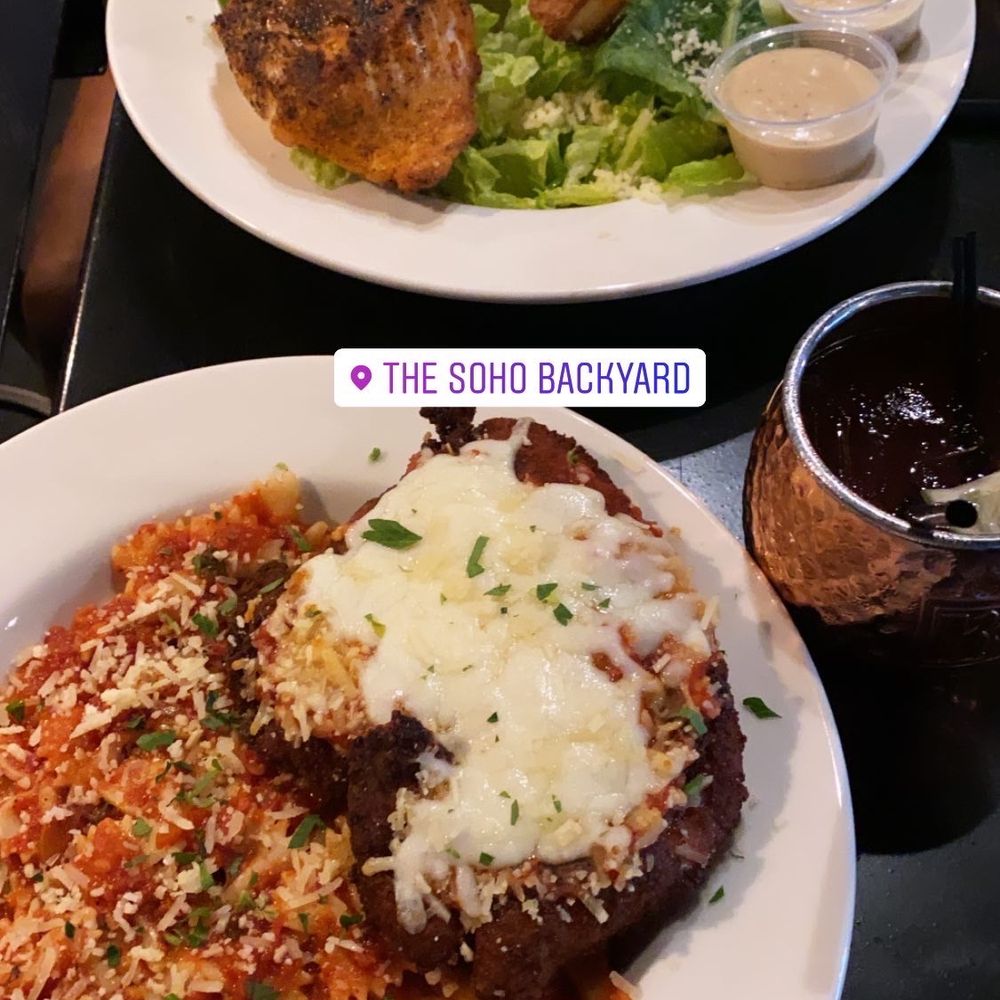 The Soho Backyard - Chicken parm and Cesar salad with salmon - Burgers Near Me - Tampa, Florida The Soho Backyard - Chicken parm and Cesar salad with salmon - Burgers Near Me - Tampa, Florida
