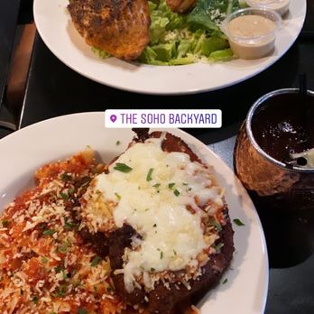 The Soho Backyard - Chicken parm and Cesar salad with salmon - Burgers Near Me - Tampa, Florida The Soho Backyard - Chicken parm and Cesar salad with salmon - Burgers Near Me - Tampa, Florida