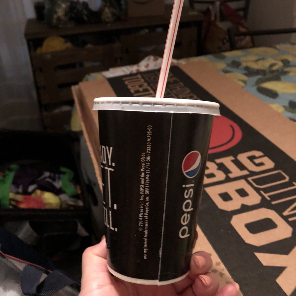 a hand holding a cup with a straw a hand holding a cup with a straw
