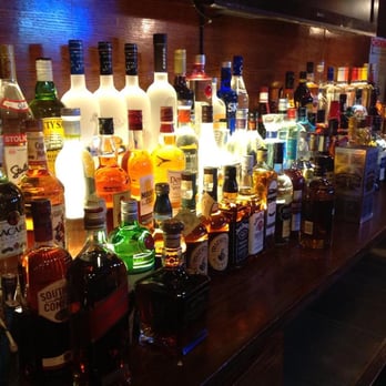 Bases Loaded - liquor bottles lined up on a bar - Sports Bars Near Me - Bronx, New York