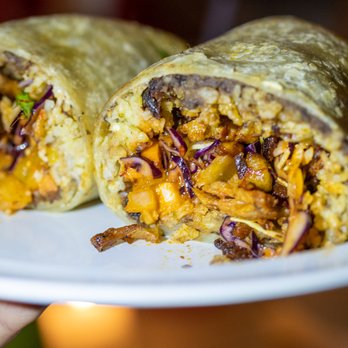 Tacombi - a person holding a plate of food - Cocktail Bars Near Me - Bethesda, Maryland Tacombi - a person holding a plate of food - Cocktail Bars Near Me - Bethesda, Maryland