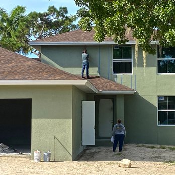 Earth View - a man standing on the roof of a house - General Contractors Near Me - Naples, Florida Earth View - a man standing on the roof of a house - General Contractors Near Me - Naples, Florida