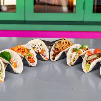 Velvet Taco - a row of taco shells on a table - Tacos Near Me - Webster, Texas Velvet Taco - a row of taco shells on a table - Tacos Near Me - Webster, Texas