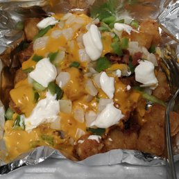 Smothered tots. Bacon, cheese sauce, onions, green peppers and sour cream on a generous portion of tater tots.