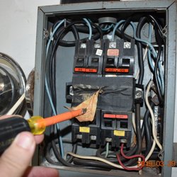 Accurate Home Inspections - Melted bus, covered by black tape. Along with over fusing. Fire waiting to happen