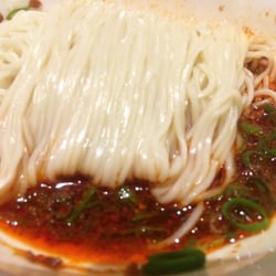 Spicy vegetarian noodles with scallions.