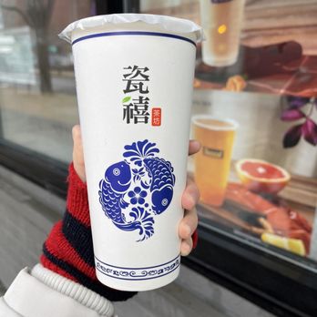 Teazzi Tea Shop - a person holding a cup of tea - Bubble Tea Near Me - Flushing, New York