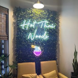 two chairs in front of a neon sign two chairs in front of a neon sign