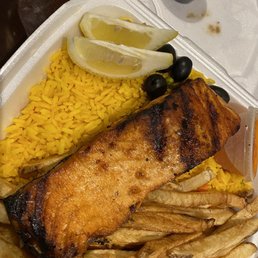 Half salmon with rice and French fries. Half salmon with rice and French fries.