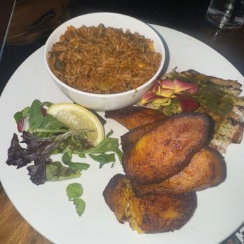 Capitaine Bar & Grill - Salmon jollof rice and plantains - Bars Near Me - Charlotte, North Carolina Capitaine Bar & Grill - Salmon jollof rice and plantains - Bars Near Me - Charlotte, North Carolina
