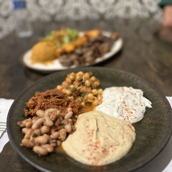 Nomadic Kitchen - Appetizer plate with hummus, chickpeas, beans, yogurt sauce and pepper paste sauce - Turkish Near Me - Redwood City, California