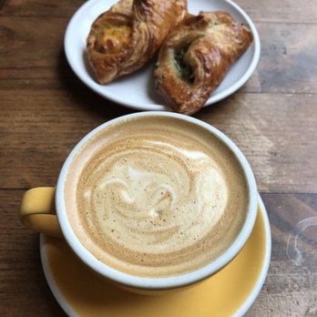 Devocion - a latte up front with a bacon egg & cheese croissant (left) & a spinach croissant (right) - Coffee & Tea Near Me - Brooklyn, New York