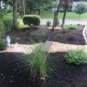 Iovino's Landscaping - a garden with black mulch - Landscaping Near Me - East Brunswick, New Jersey Iovino's Landscaping - a garden with black mulch - Landscaping Near Me - East Brunswick, New Jersey