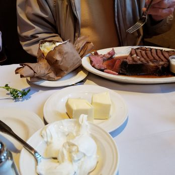 Andria's Steakhouse - Dad's massive cut of prime rib and over sized baked potato - Steakhouses Near Me - O Fallon, Illinois