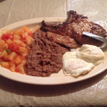 Las Lomitas - Pork Chop and eggs with a side of Papas a la Mexicana and Refried Beans. - Tex-Mex Near Me - Hebbronville, Texas