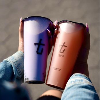 Tbaar Park Slope - a person holding two cups of coffee - Bubble Tea Near Me - Brooklyn, New York Tbaar Park Slope - a person holding two cups of coffee - Bubble Tea Near Me - Brooklyn, New York