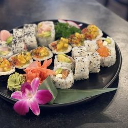 Sushi Spot - From right to left:  Phili roll, Specialty roll with some white tuna,  Costume roll with Yellowtail, avocado and deep fried asparagus