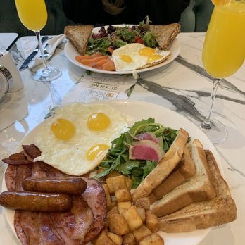 Evviva Breakfast & Lunch - Bacon, sausage and ham with 3 sunny side up eggs along with a mimosa. - Breakfast & Brunch Near Me - Vaughan, Ontario Evviva Breakfast & Lunch - Bacon, sausage and ham with 3 sunny side up eggs along with a mimosa. - Breakfast & Brunch Near Me - Vaughan, Ontario