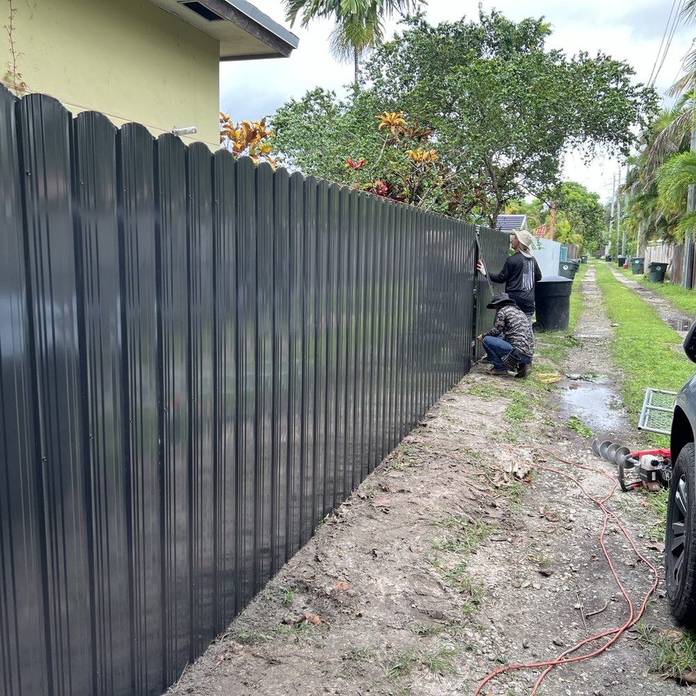 New metal fence with gate during construction.