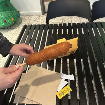 Kong Dog - Chicago - a person holding a piece of bread - Hot Dogs Near Me - Chicago, Illinois