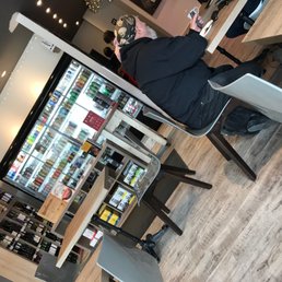 a man sitting at a table in front of a vending machine