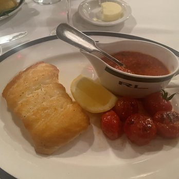 RL Restaurant - Chilean sea bass lightly breaded with pepper and paprika sauce and broiled cherry tomatoes on the side. Yummy! - New American Near Me - Chicago, Illinois