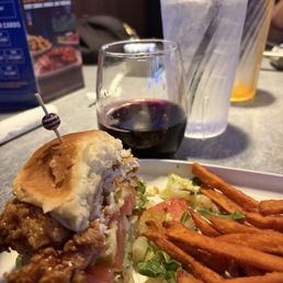 Spicy crispy chicken sandwich with Korean barbecue sauce, and sweet potato fries Spicy crispy chicken sandwich with Korean barbecue sauce, and sweet potato fries