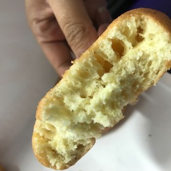 Dunkin' -  a hand holding a half eaten doughnut - Coffee & Tea Near Me - Capitol Heights, Maryland