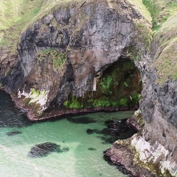 Carrick-a-rede Rope Bridge - sea cave entrance below Carrick-a-Rede Rope Bridge - Local Flavor Near Me - Ballintoy, ANT