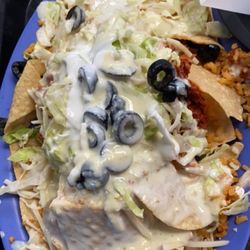 Blue Coast Burrito - Spicy chicken Nachos with, cheese, lettuce, black olives, sour cream, and queso :)