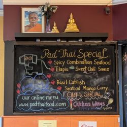 Pad Thai Restaurant - Specials board with different dishes ps. Love the shrine!