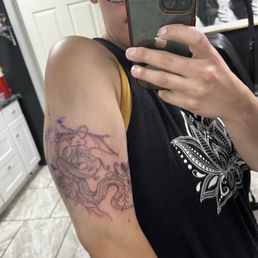 Dragon tattoo with flowers by Angie
