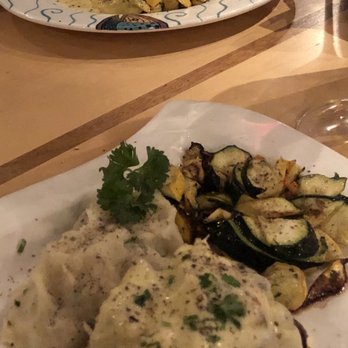 Anthony's at Spokane Falls - Close plate: Filet Oscar (topped with crab), sides of seasonal vegetables and mashed potatoes.  Back Plate: Wild River Salmon - Seafood Near Me - Spokane, Washington
